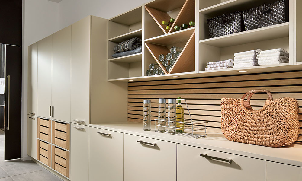Modern utility room with open shelving, wood panelled wall and practical storage solutions for cleaning and household supplies