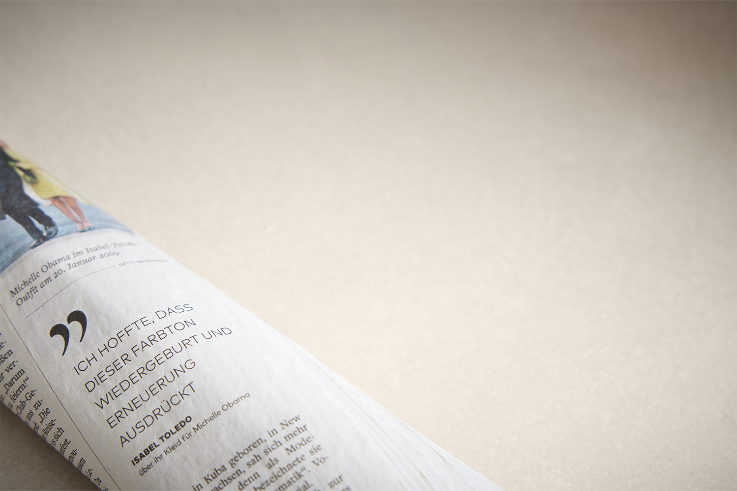 The bright pronorm worktop, matching the warm, light kitchen in Angora grey. A rolled-up newspaper is stylishly placed on top.
