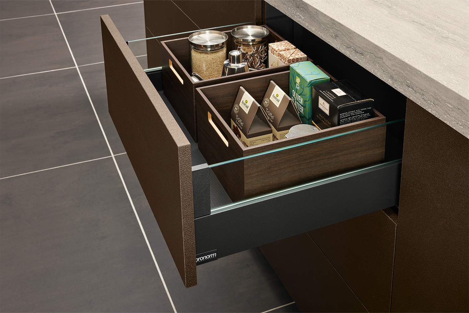Open drawer with proTech X side panels and high-quality wooden inserts, part of the handleless design kitchen by pronorm