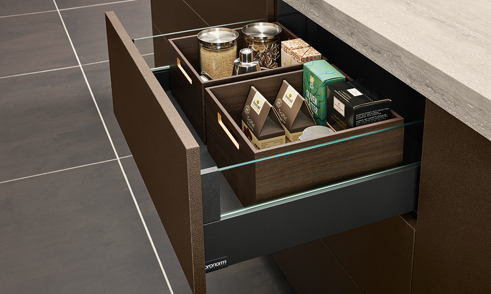 Luxurious pronorm drawer with wooden boxes and glass side panels – ideal for dry food storage.