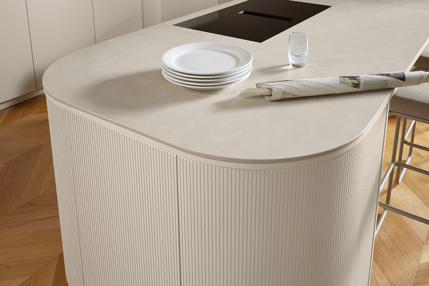 Close-up of the elegant curve on the kitchen island featuring vertical fluted fronts in Angora grey.