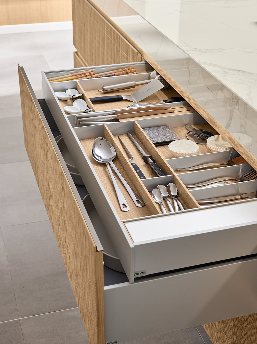 Open drawer in Boho-style Y-line kitchen featuring a premium cutlery insert, showcasing functional design and natural oak interior