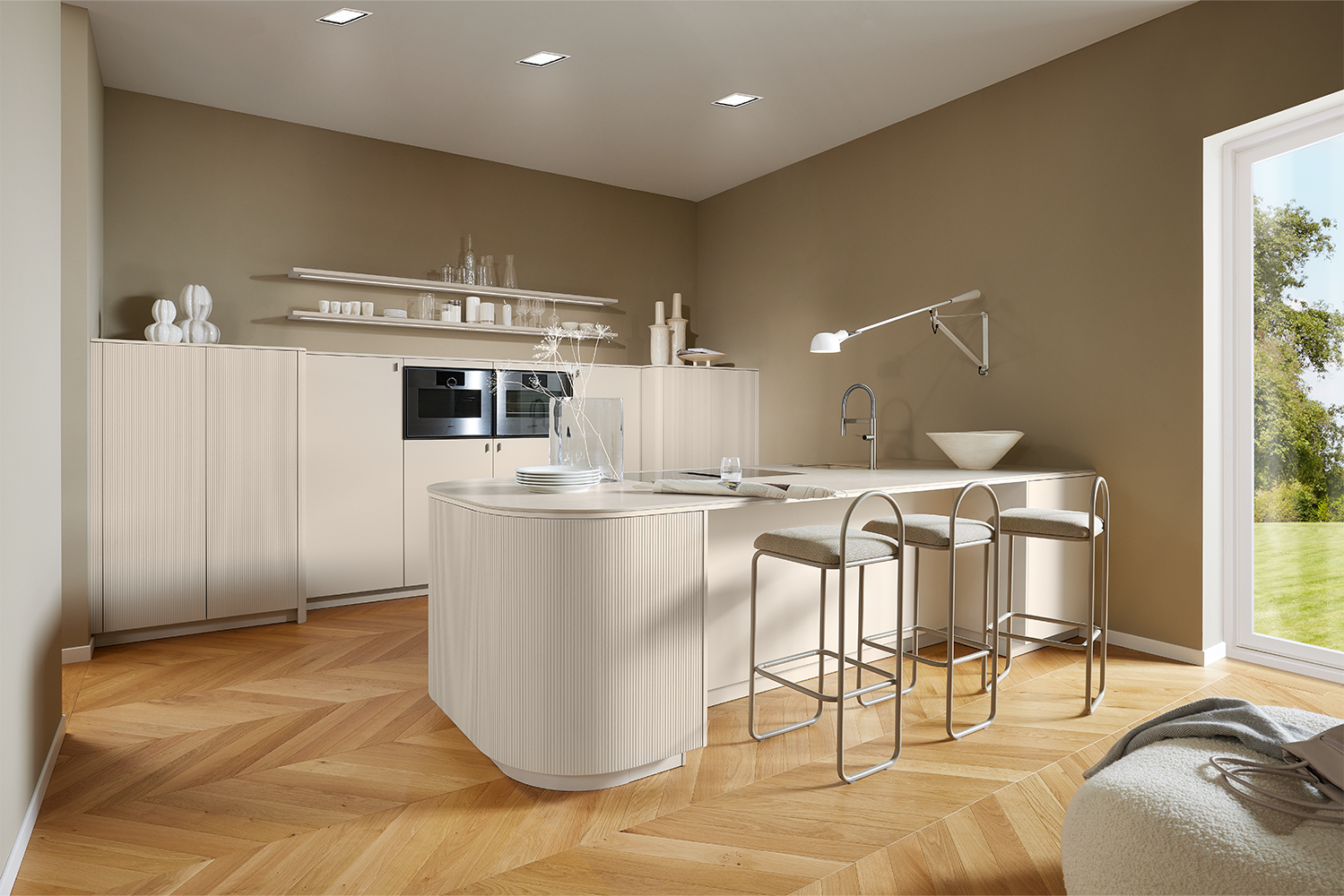 Full view of a modern kitchen with curved island, fluted Angora grey fronts and matching sideboard and highboard by pronorm.