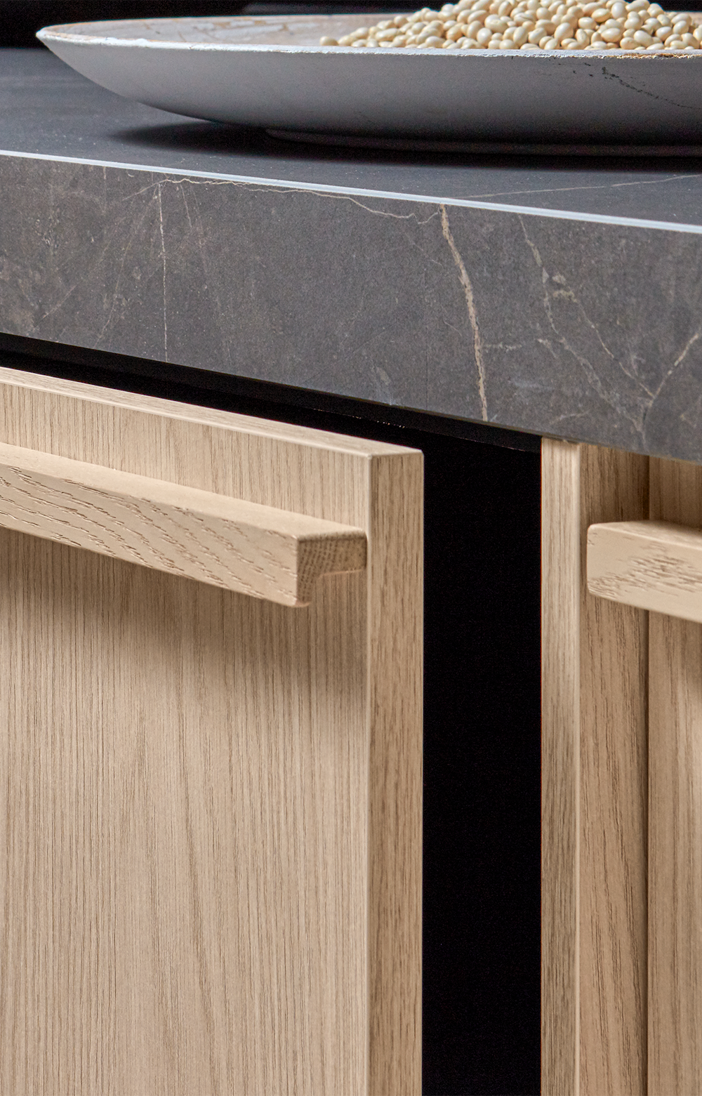 A close-up of an open framed front made of light oak.