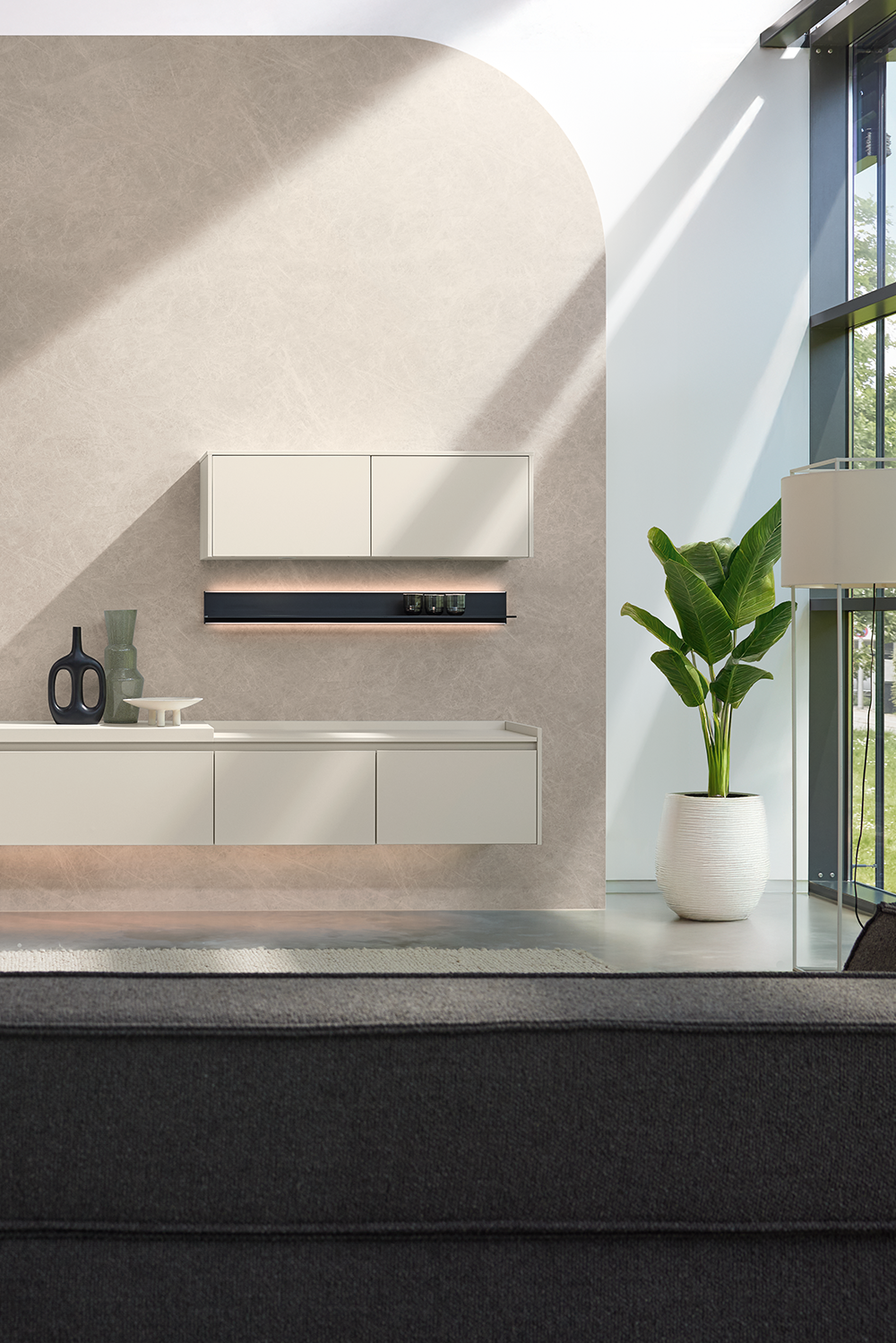 Modern pronorm wall unit in matt white with floating elements and minimalist décor in a bright living space.