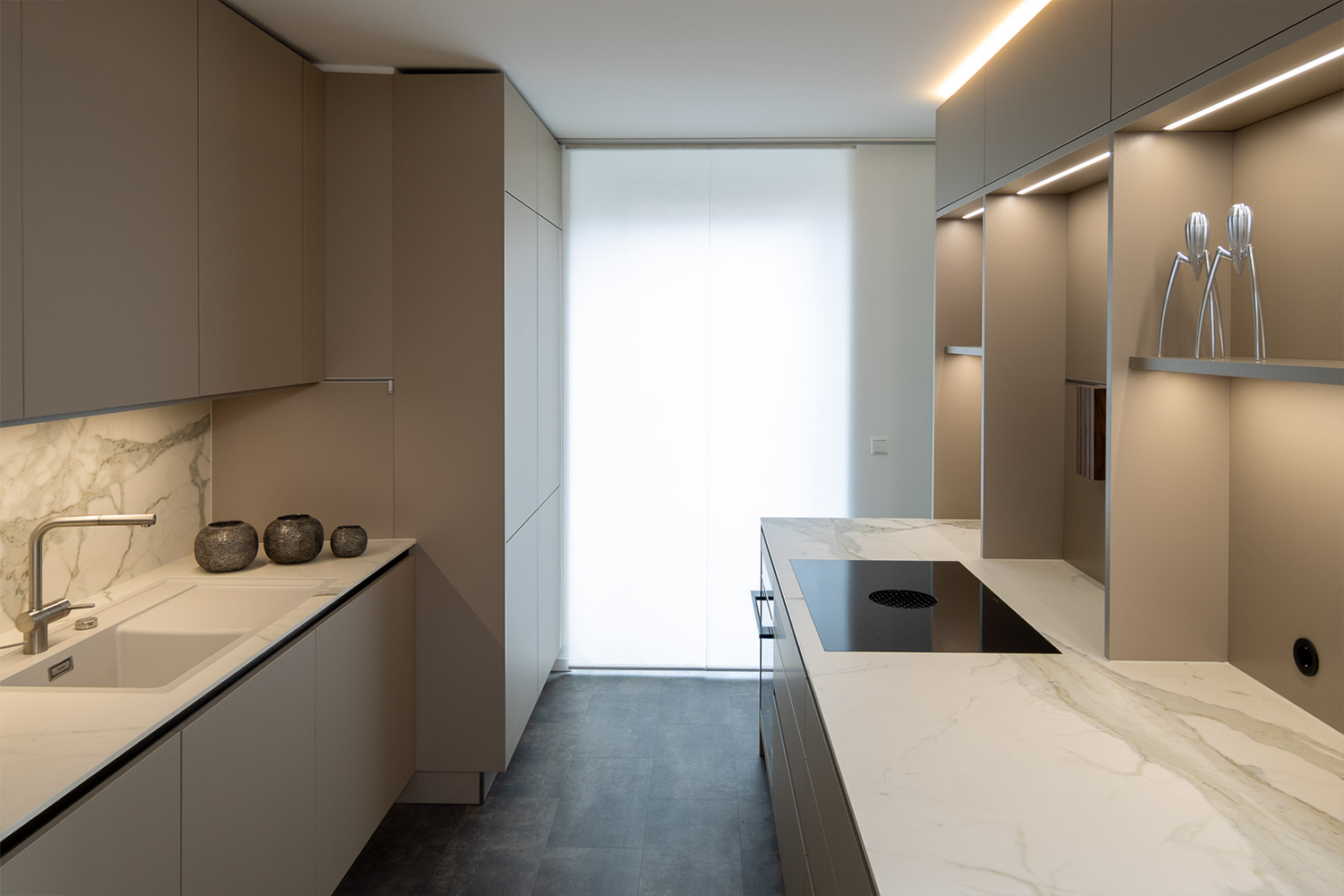 Moderne inbouwkeuken van pronorm met verlichte achterwand en elegante werkblad.