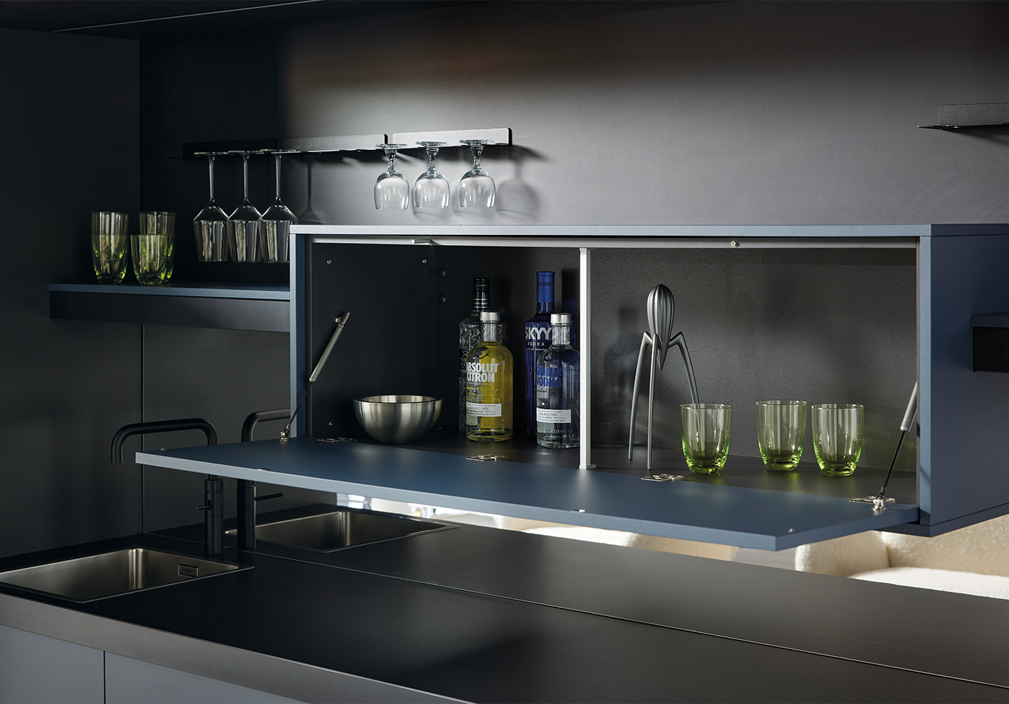 You see an open bar compartment in a pronorm designer kitchen with glass holders, bottle storage and premium craftsmanship.