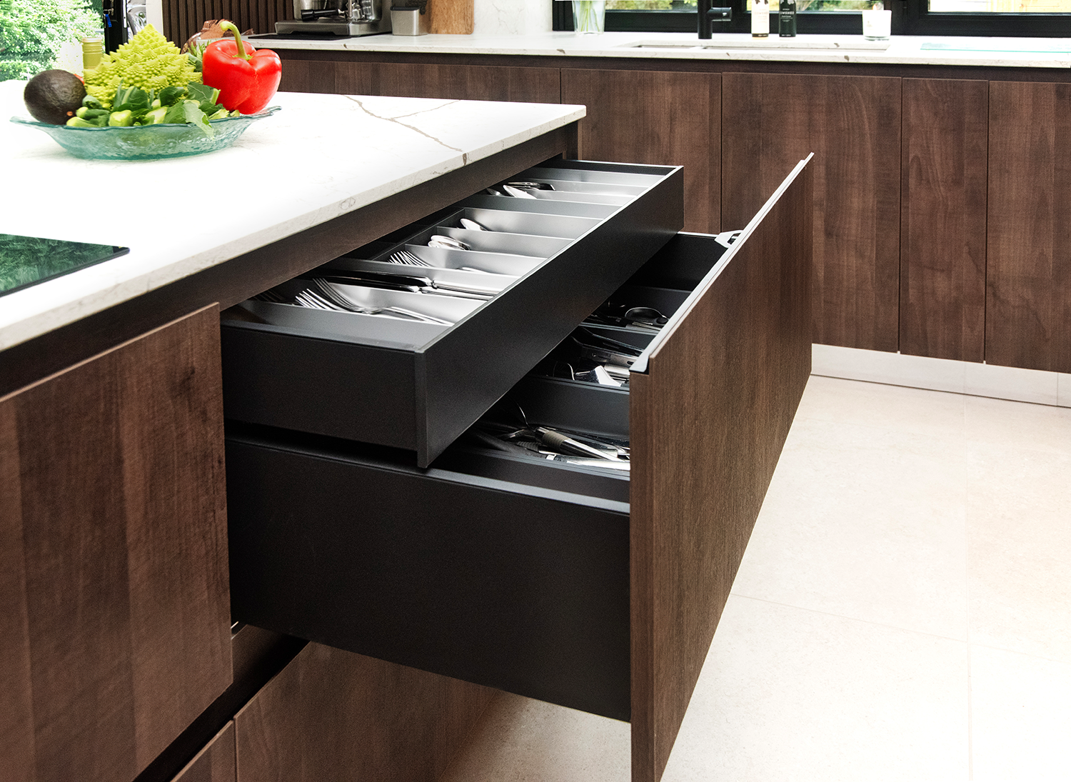 Handleless pronorm kitchen with drawers, cutlery insert and smart storage solutions.