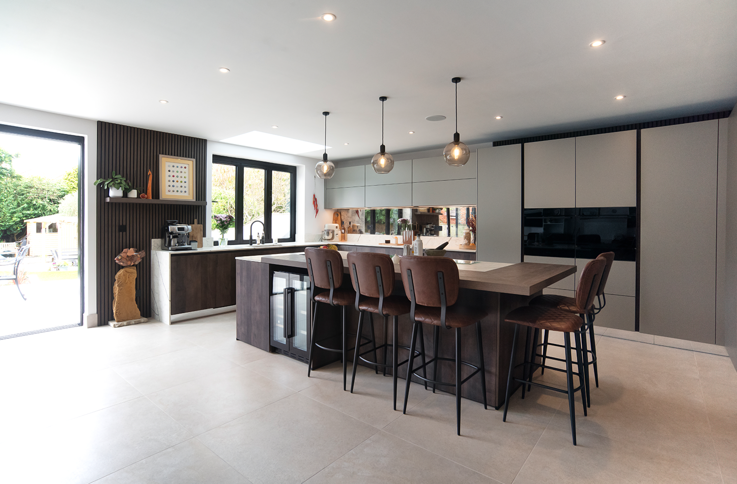 Minimalist pronorm industrial-style kitchen with central island in open living space.