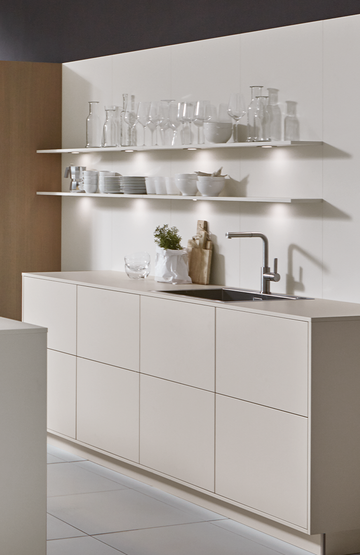 bright pronorm kitchen with two illuminated shelves above the worktop.