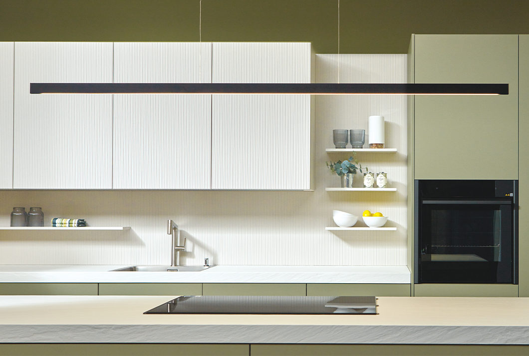 pronorm kitchen in jade green and white with a pendant light above the kitchen island.