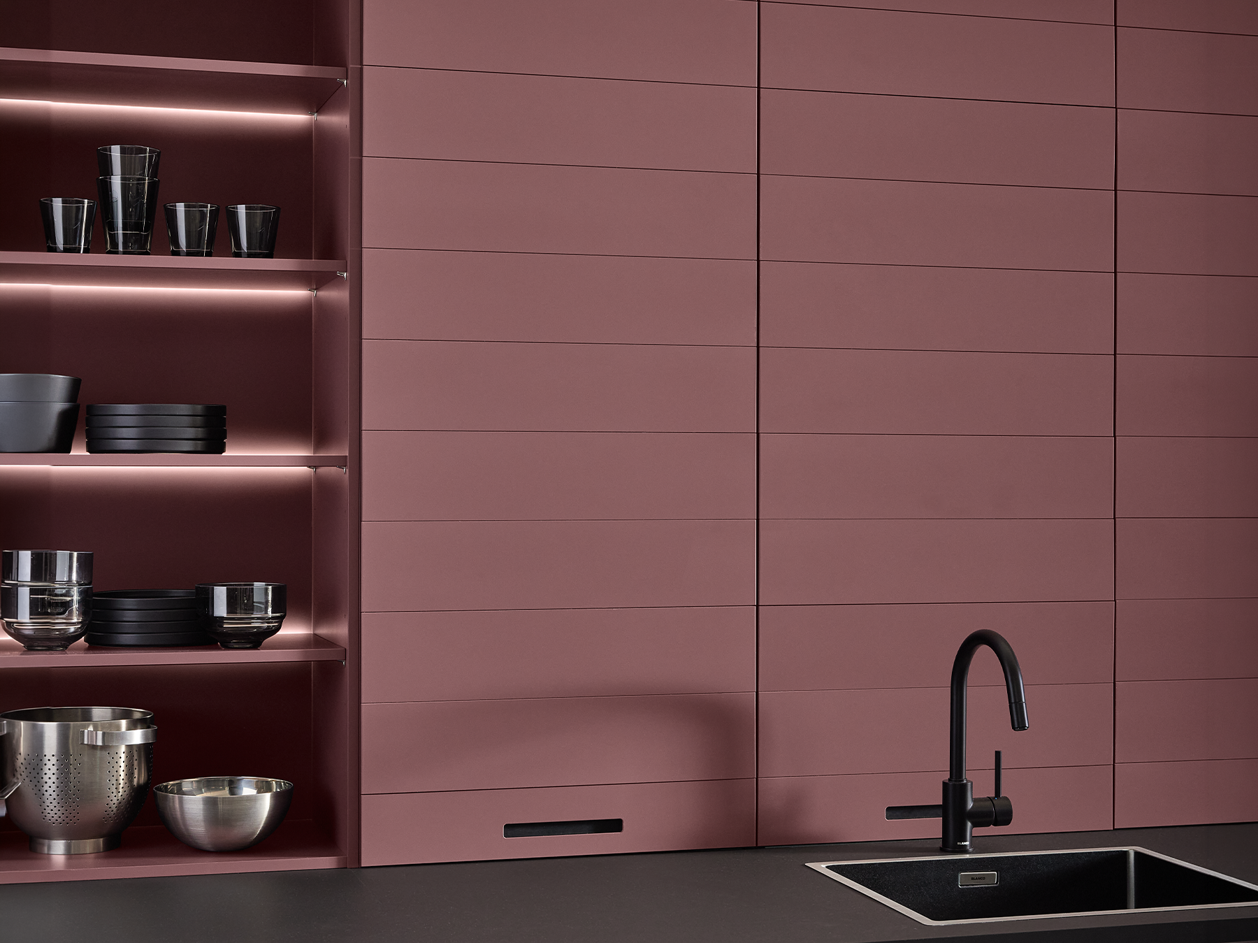 pronorm kitchen with practical flip doors fully open for quick access to hidden storage.