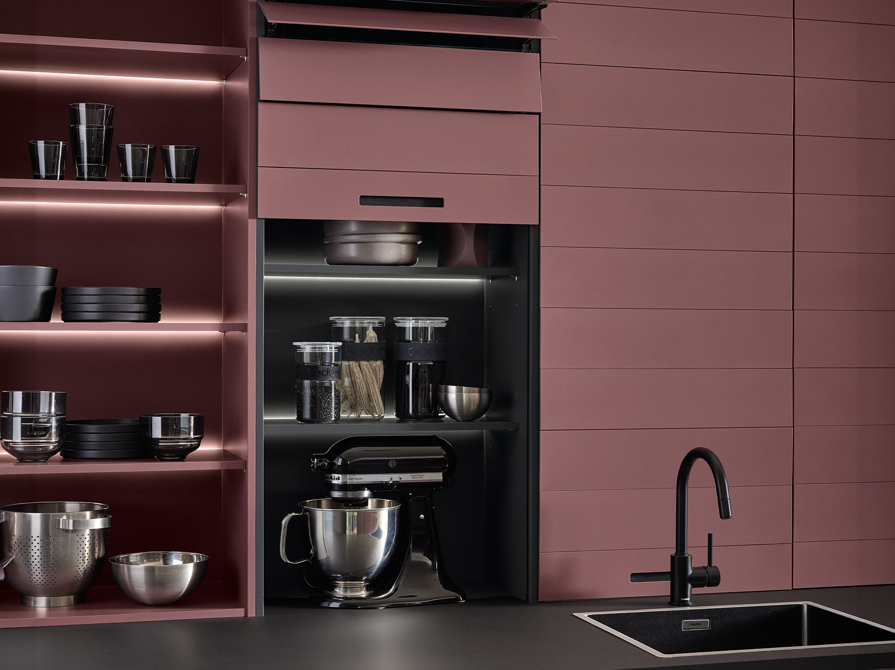 pronorm kitchen with practical flip doors half open for quick access to hidden storage.