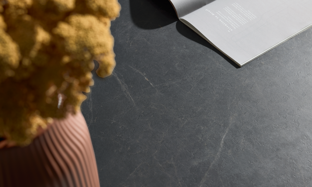 Dark grey marble Emperador stone look worktop with fine golden veining as an elegant kitchen detail