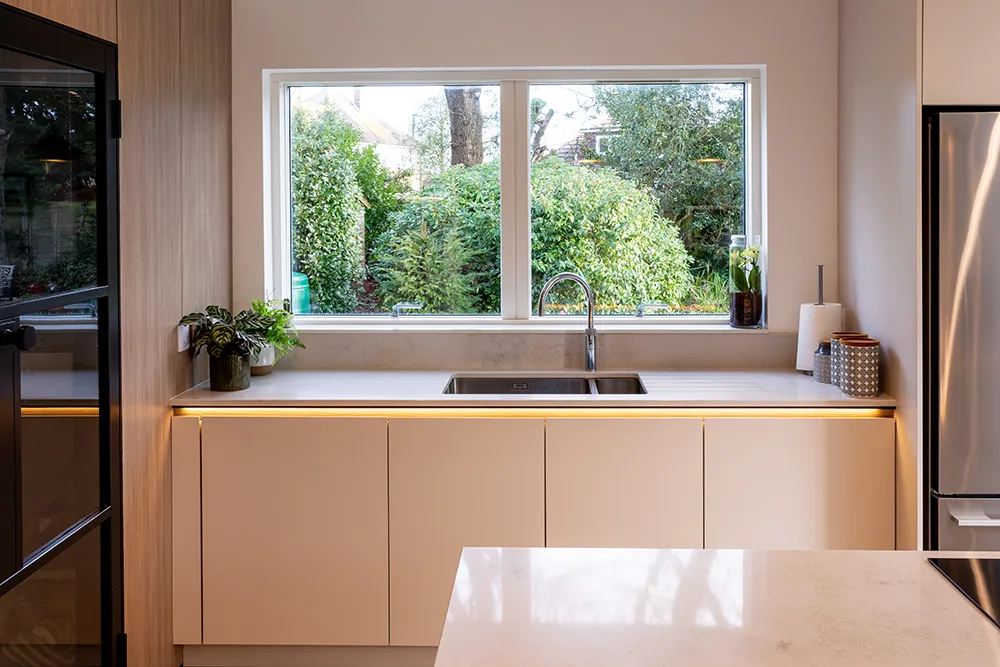 Handleless Scandinavian kitchen by pronorm with a minimalist kitchen island.