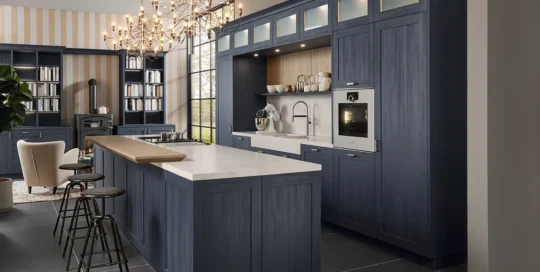 Modern country-style kitchen with blue wood-frame fronts featuring visible grain.