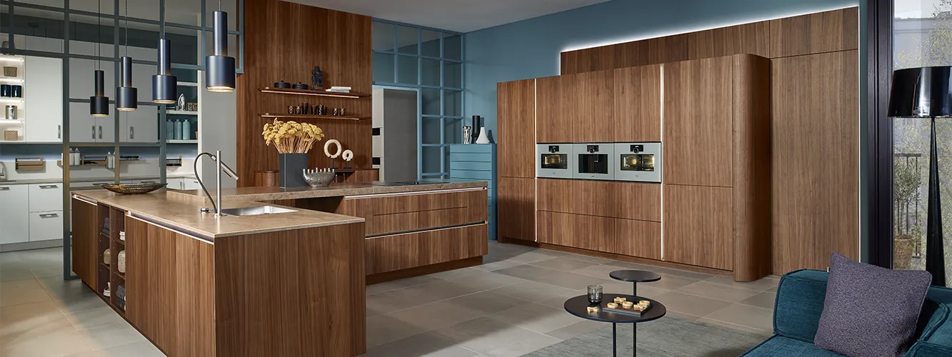 pronorm dark-toned kitchen with wood fronts and integrated lighting design